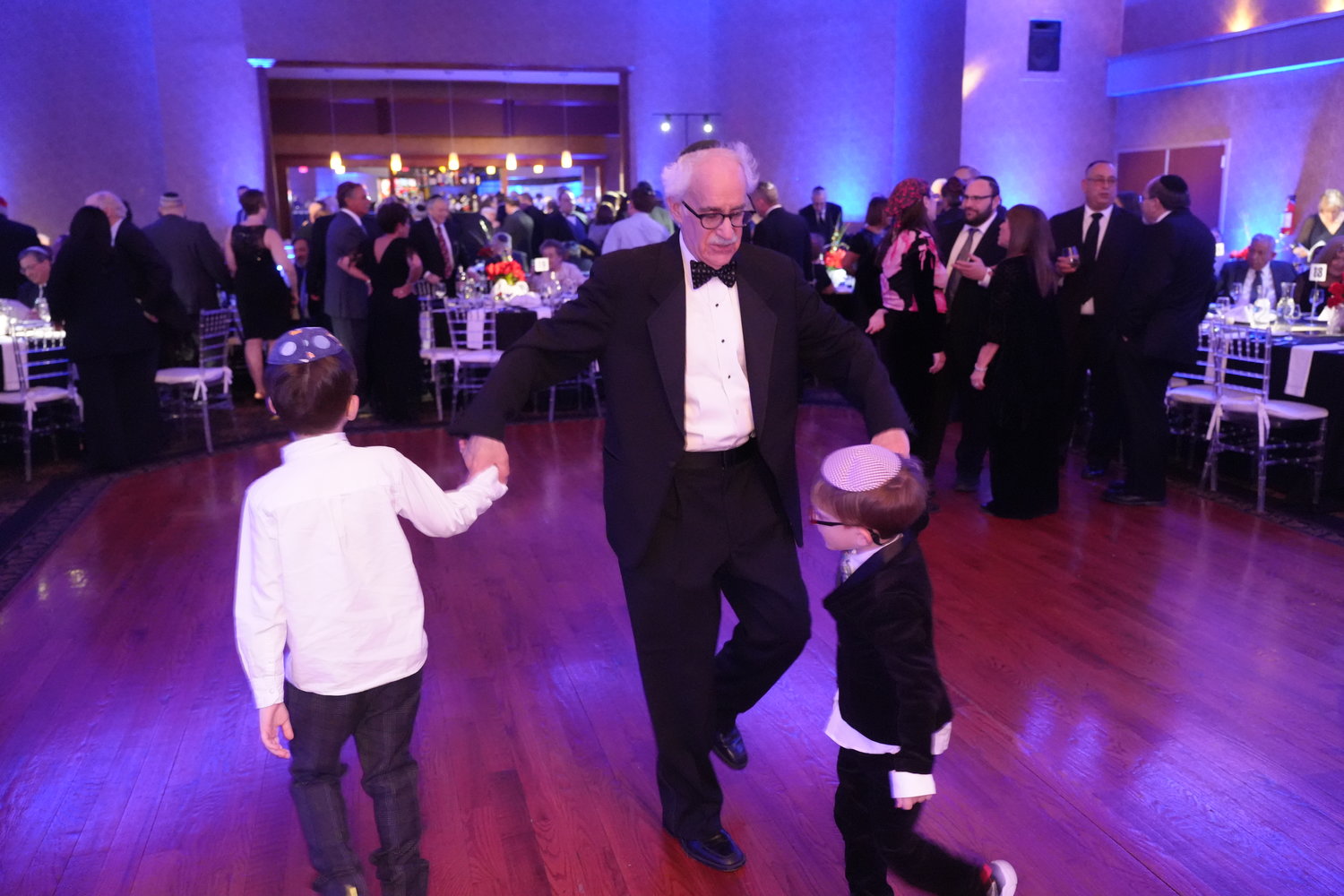 Androphy danced with two of his grandsons at his retirement gala