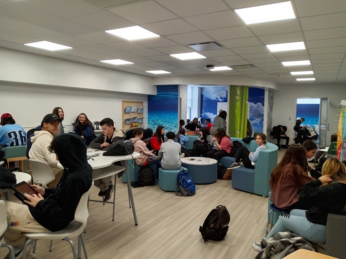 A Crowded Oceanside High School Wellness Center shows the many ways in which students can use the space, with friends or alone, to decompress and relax during their off periods.