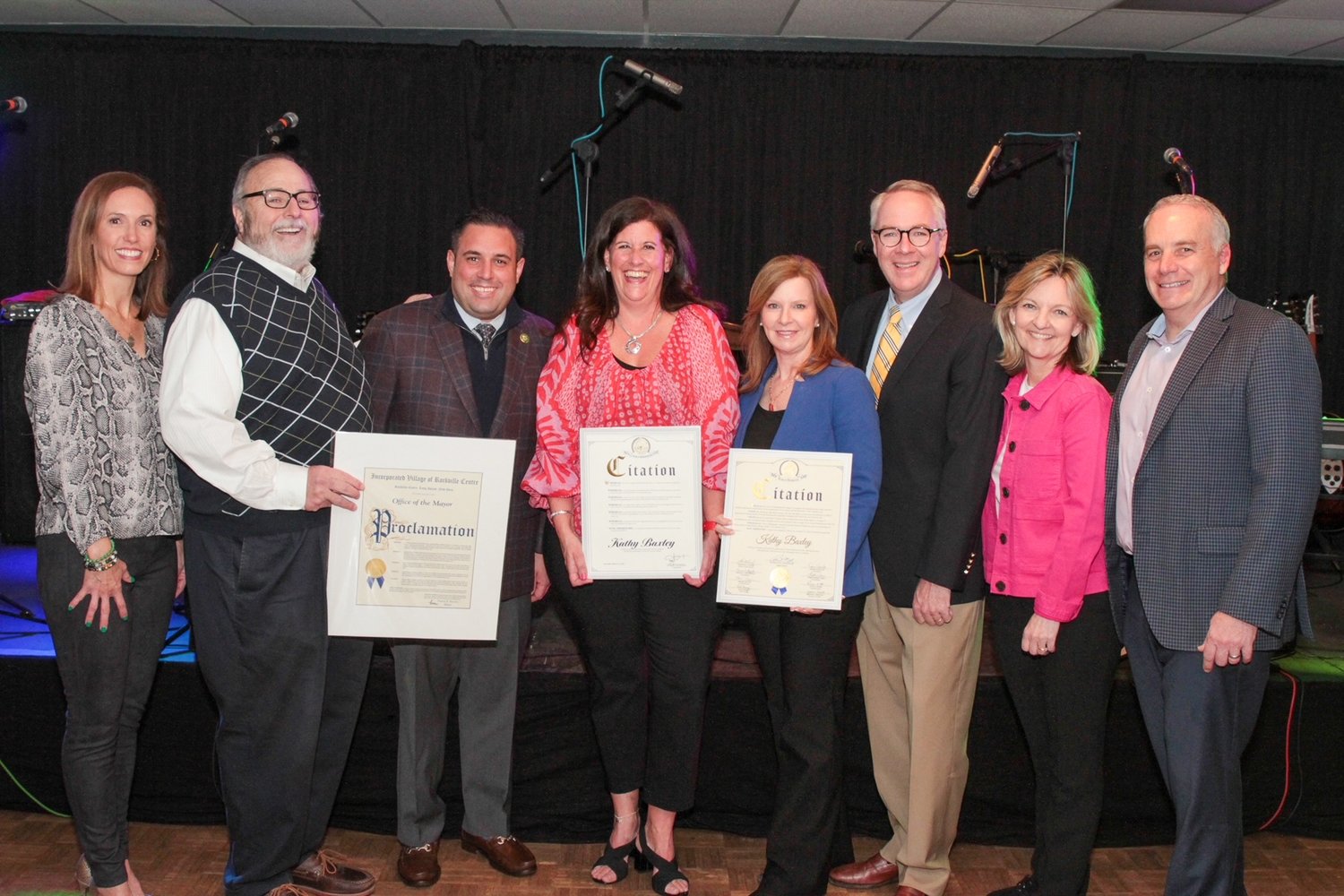 Rockville Centre Deputy Mayor Kathy Baxley, center, is honored by Village Trustee Katie Conlon, left, Mayor Francis Murray, U.S. Rep. Anthony D’Esposito, Hempstead Town Councilwoman Laura Ryder, Hempstead Town Supervisor Don Clavin, RVC School board Vice President Donna Downing, and Village Trustee Emilio Grillo for her service and dedication to Senior Services.
