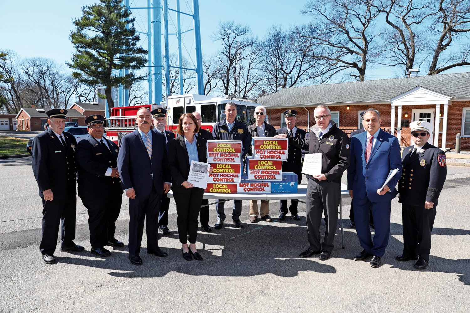 Hempstead Town Supervisor Don Clavin, North Hempstead Town Supervisor Jen DeSena, Oyster Bay Town Supervisor Joseph Saladino and the Albertson Fire Department surround the more than 30,000 names in opposition to Governor Hochul’s Housing Compact at the Albertson Water District.