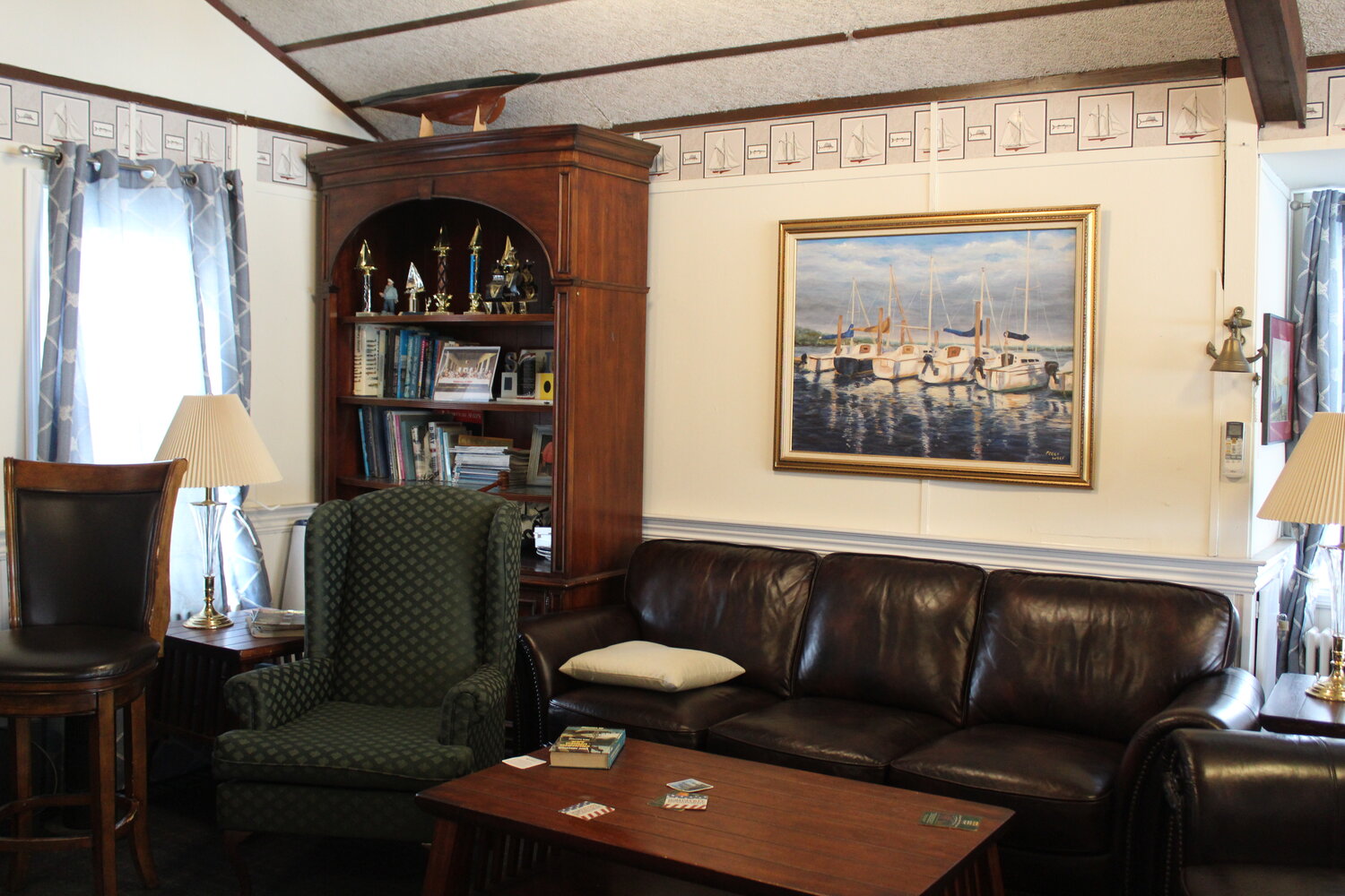 A view inside the Hempstead Bay Sailing Club features books, medals, and lounging space for club members.