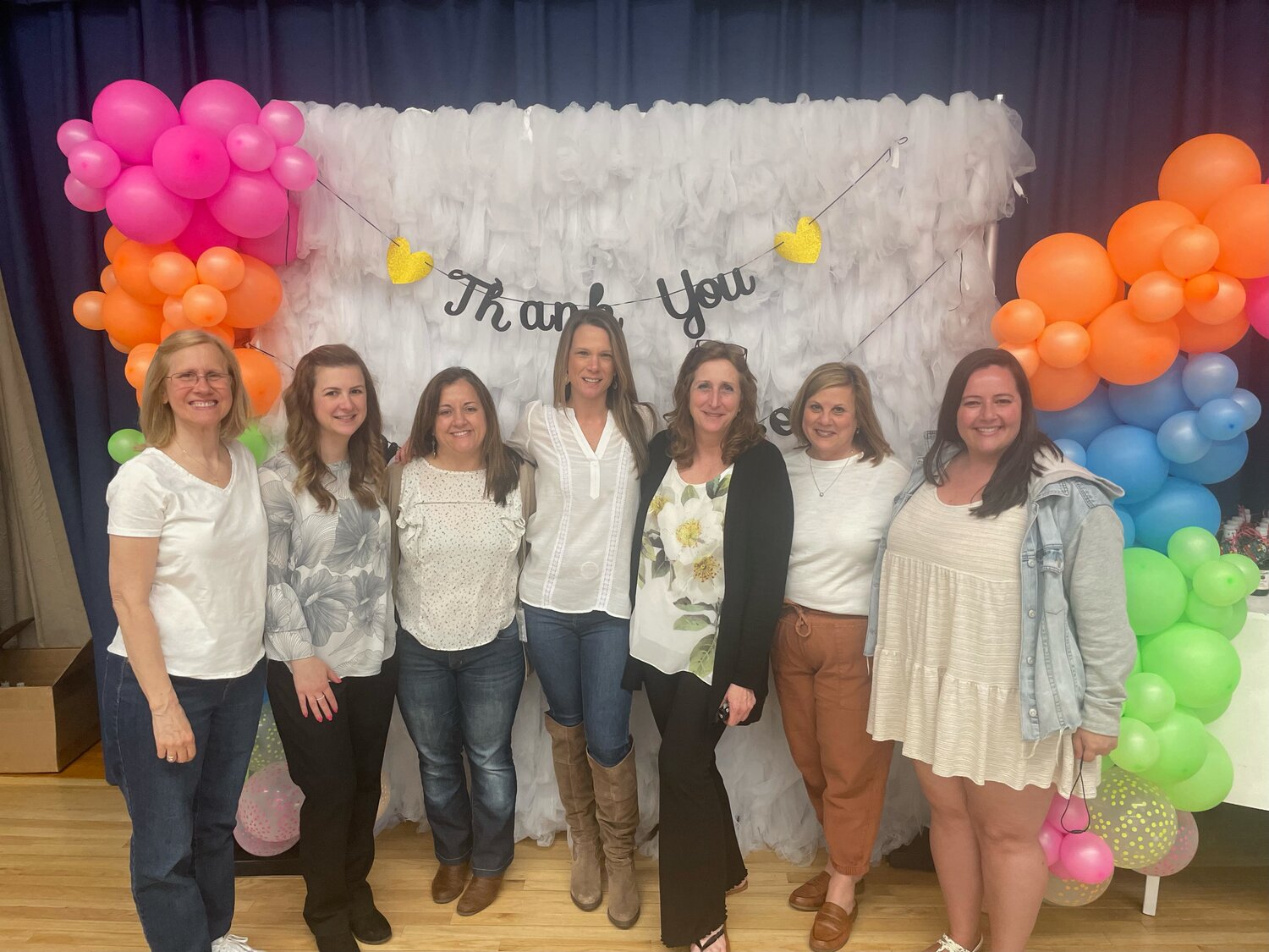 Fifth grade teachers posed in front of the ‘80s themed banner.