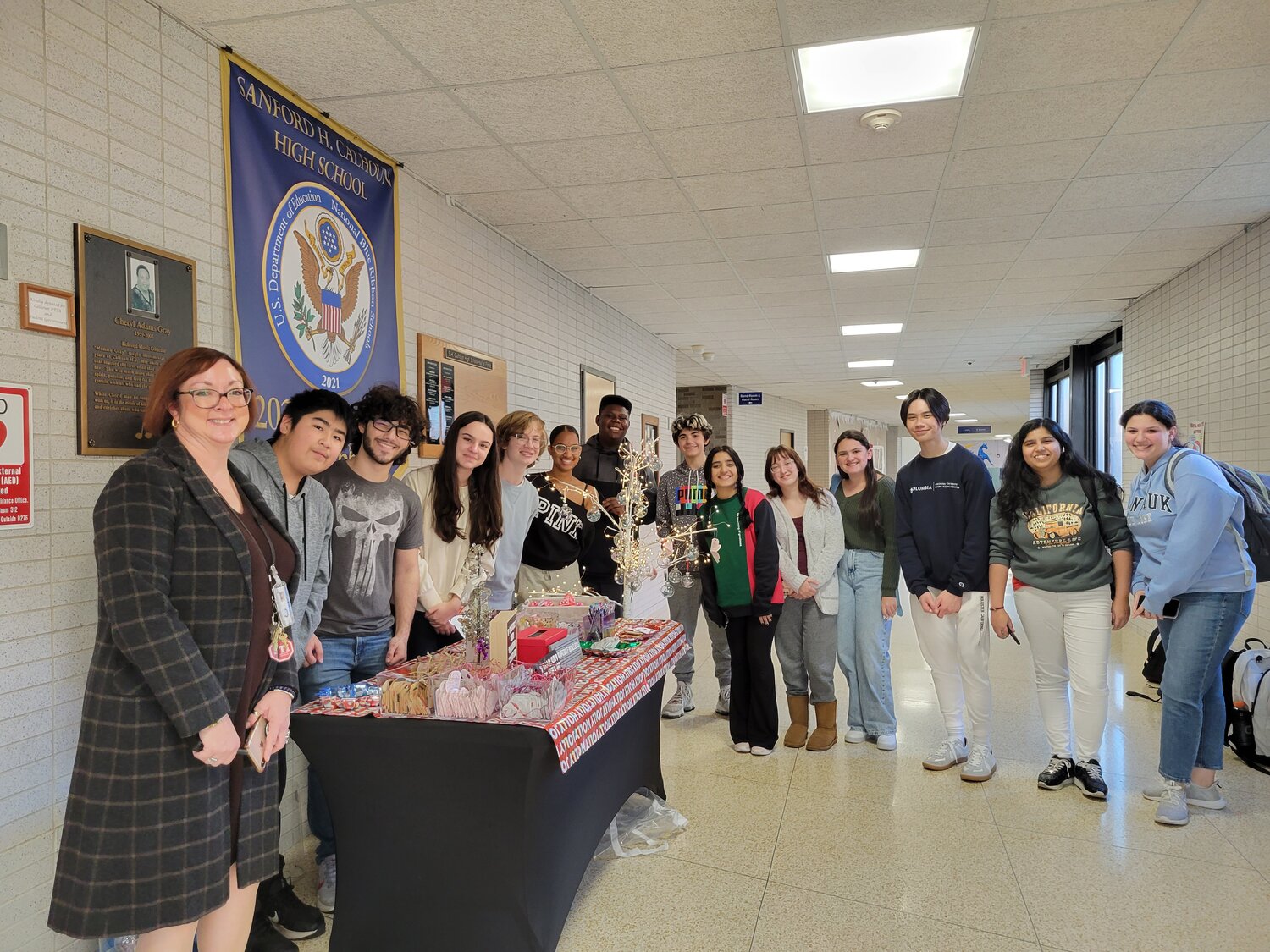 Members of Calhoun’s OHO Lab around a table in school, where they helped spread the mission of the club, which sends inspirational messages to prisoners as part of a free book exchange.