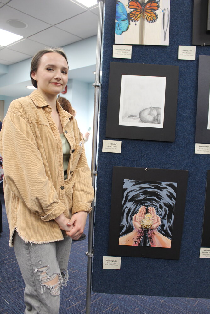 South Side High School artist Grace Kilarjian with her piece ‘Duckling in Oil,’ which was one of 80 submissions from across the 4th Congressional District on display.