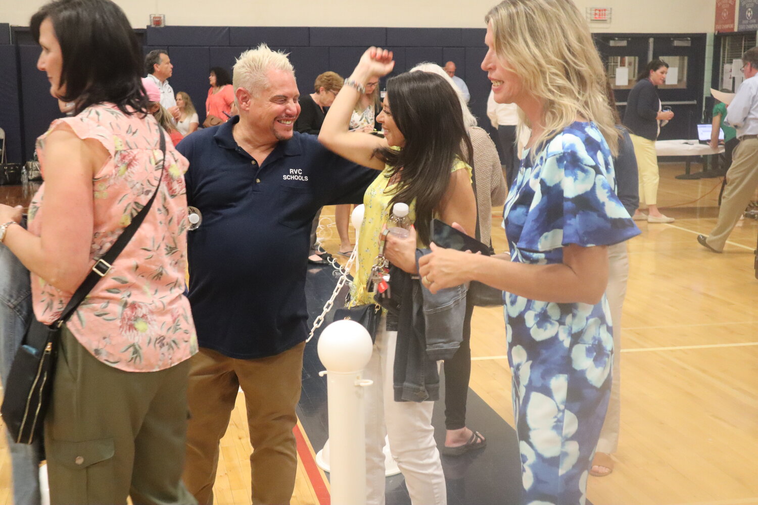 Tara Hackett celebrates her re-election to the Rockville Centre education board at the South Side High School gymnasium Tuesday night.