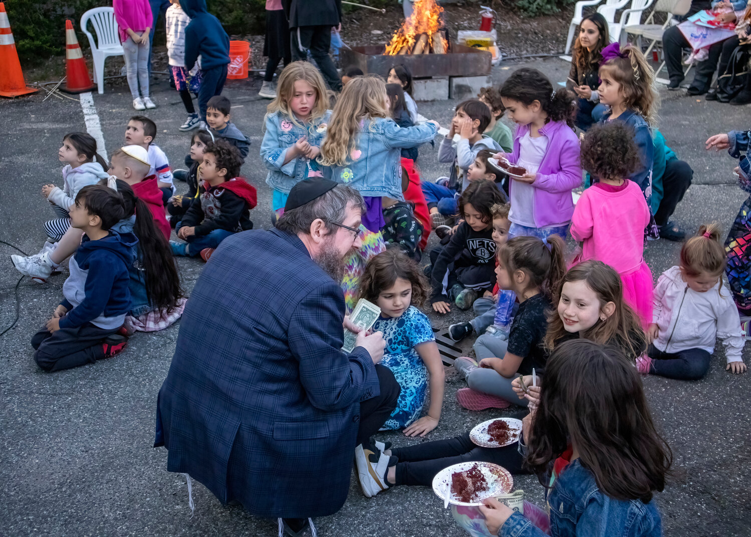 Rabbi Shimon Kramer, near left, director of the Chabad Center, met with some of the children who were both learning about Lag B’Omer and celebrating the holiday.