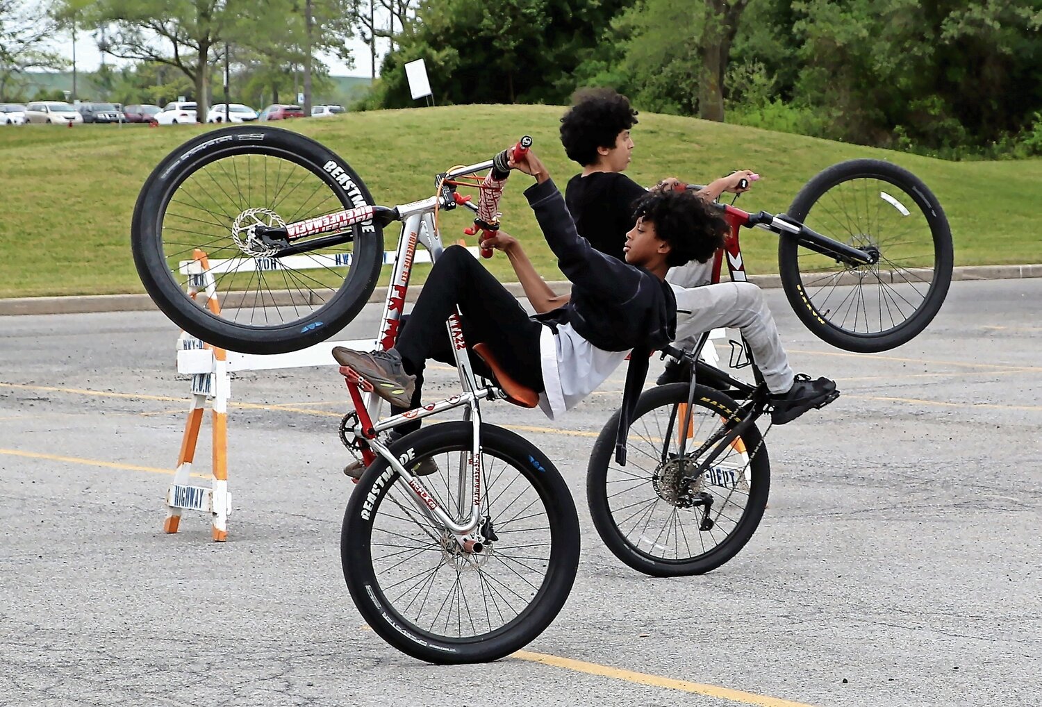 Matthew Romero, 16, and Eli Willis, 13, shows off some of their tricks while riding their bikes.