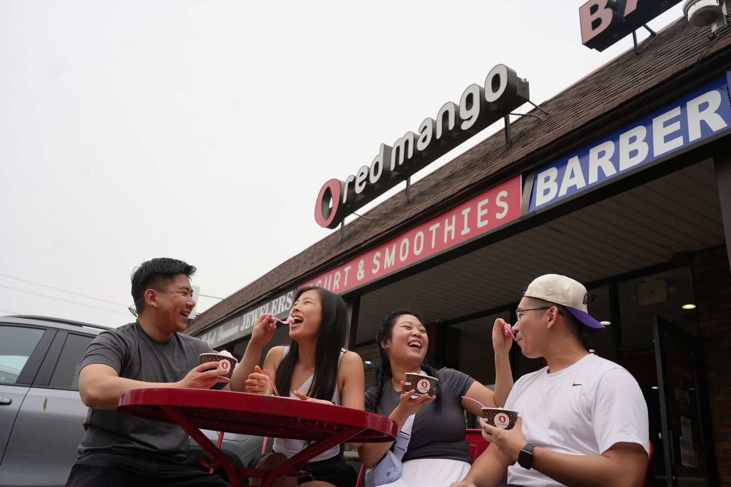 Gordon Chai, left, Emily Chen, Karina Lam and Perry Chen enjoy some frozen yogurt outside Red Mango in Franklin Square at its 10th anniversary celebration.