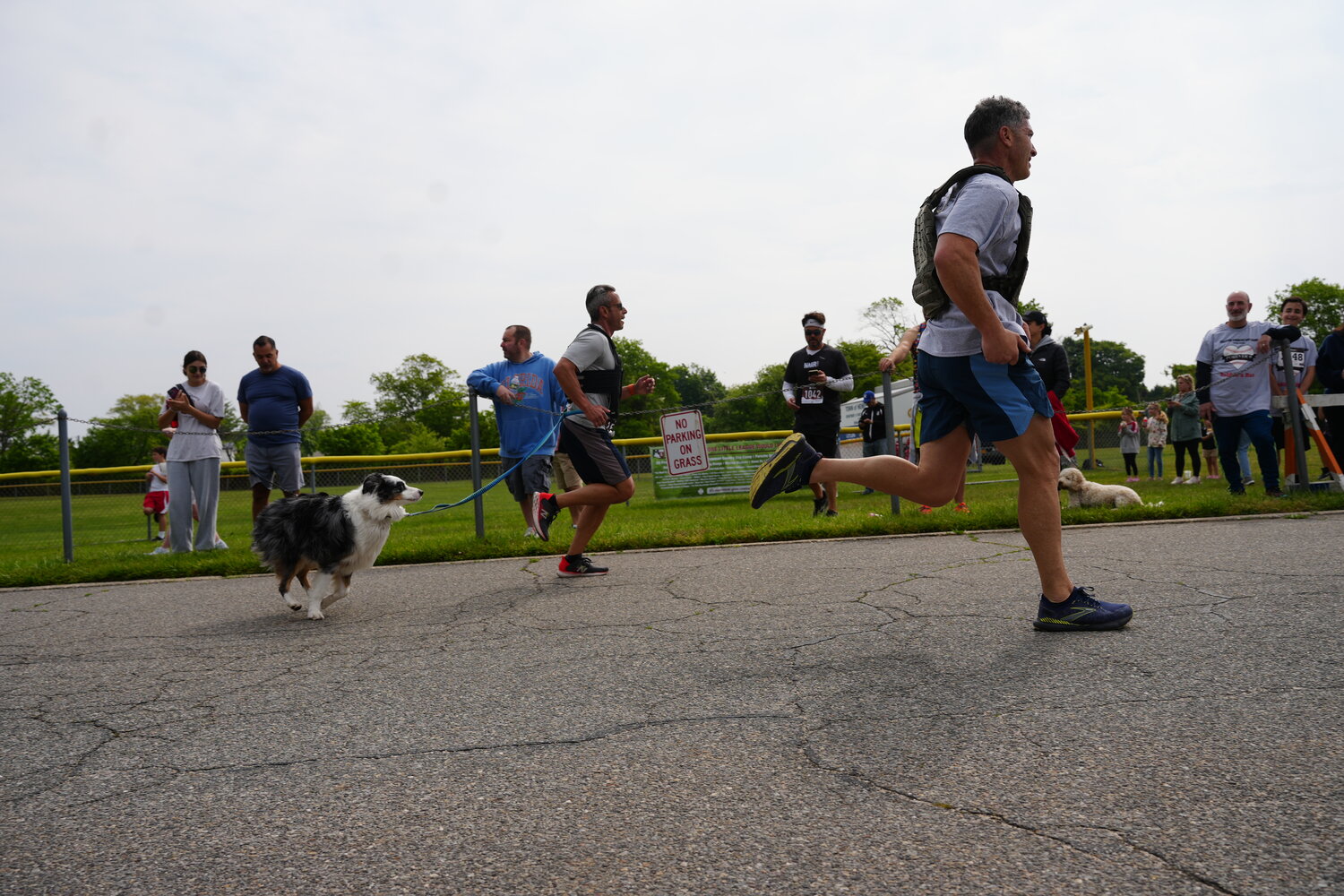 The even attracts         hundreds of      runners every year for a 5K, 1-mile mini run and     half-mile children’s run. Even a pup, left, joined in on the fun on Sunday.