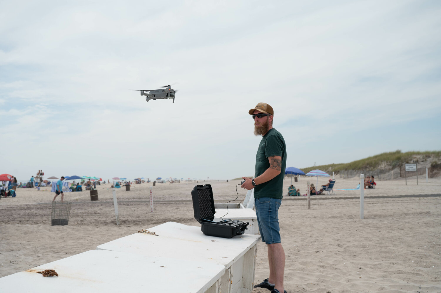 A state employee demonstrates how a drone works to identify sharks in the waters of Long Island’s South Shore beaches.