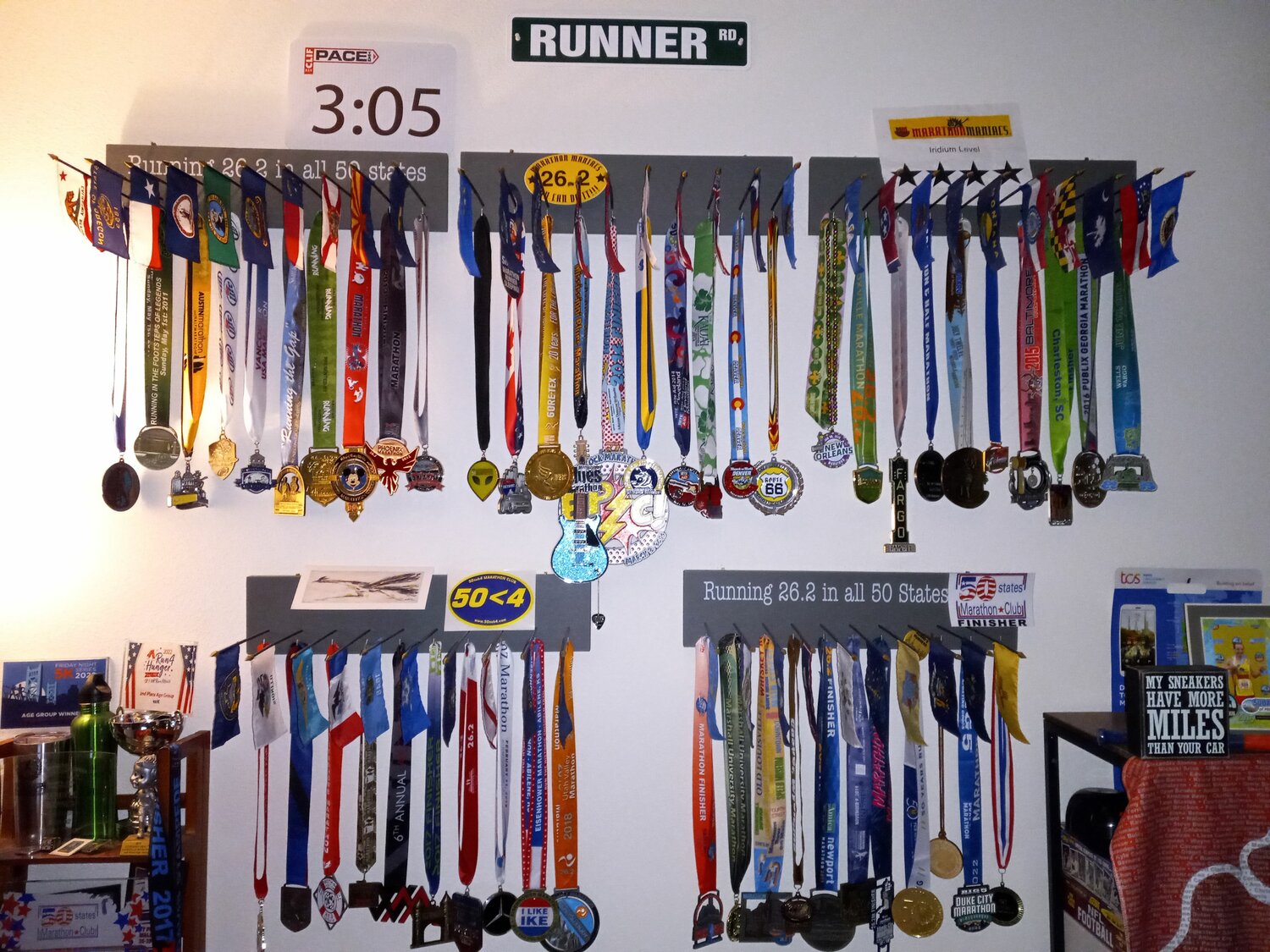 Each of Randell Hansen’s 50 marathon medals, above, with each of their respective state flags.