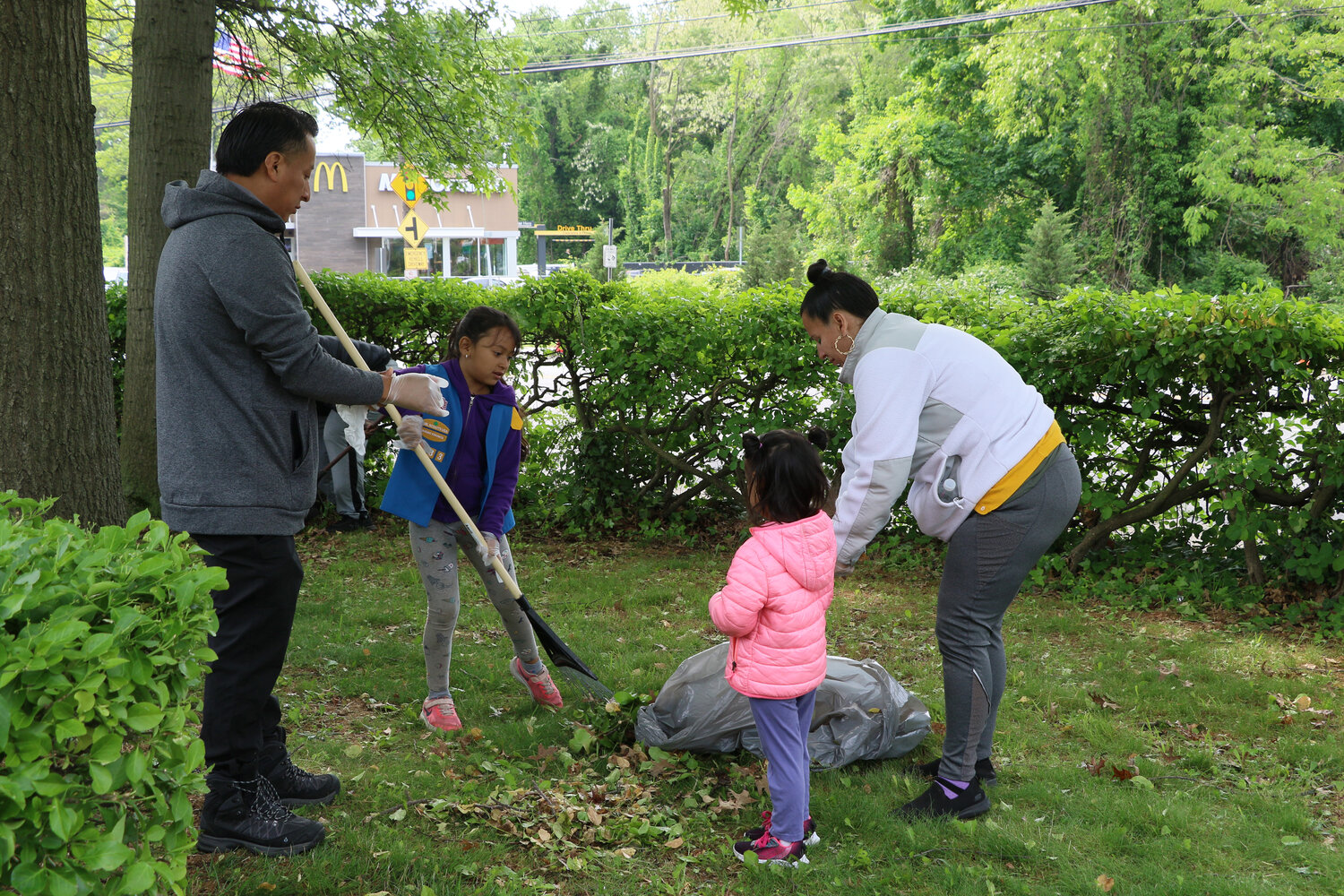 Joany and Miguel Garcia-Tzul, parents of Adriana and Girl Scout Gabriella, working hard to beautify their neighborhood.