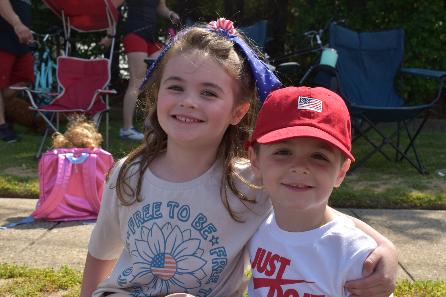 Lily and Rory Briody, ages 5 and 3 of Merrick, watched the parade and ceremony in their best red, white and blue spirit wear.