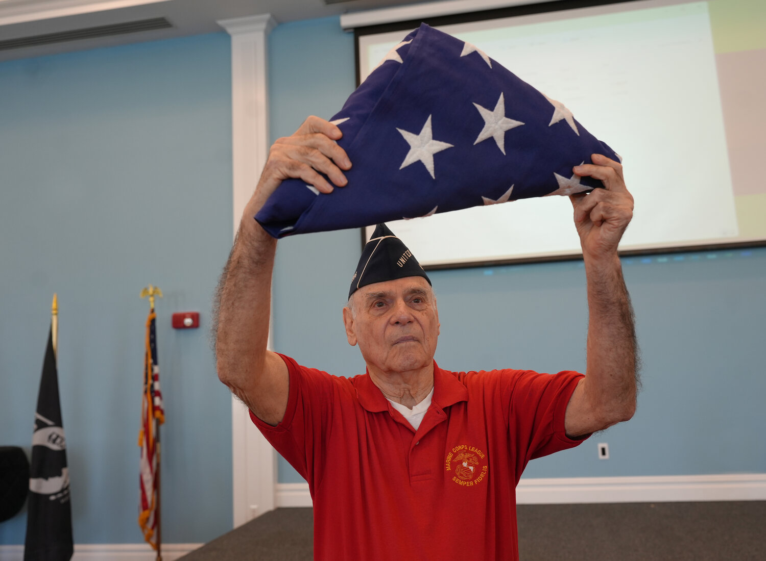 US Marine Corps veteran Len Goldstein shows how to properly fold the American flag.