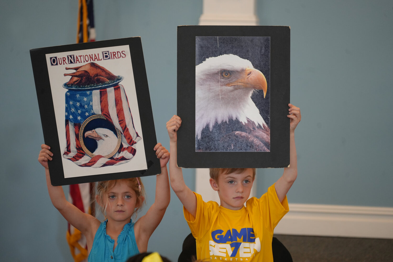 Abigail Ferro, left, and Benjamin Rzeszut hold up images of our national bird, the American Bald Eagle.