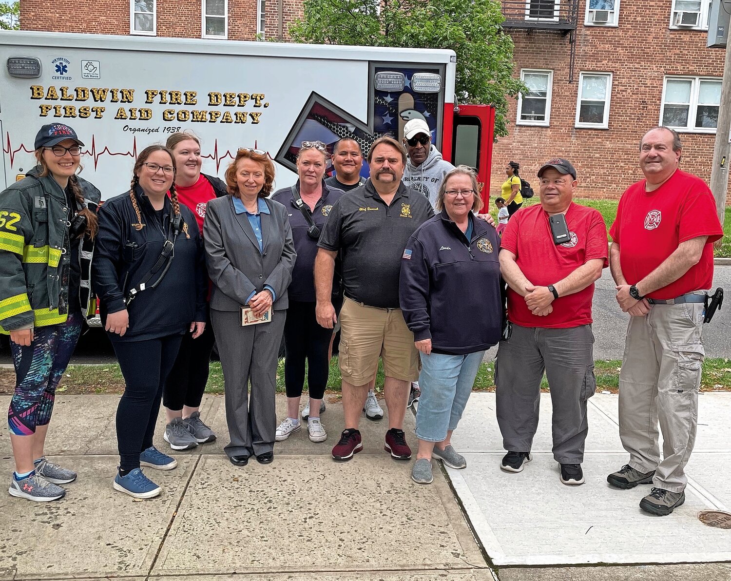 Patricia Maher, fourth from left, with members of the Baldwin Fire Department.