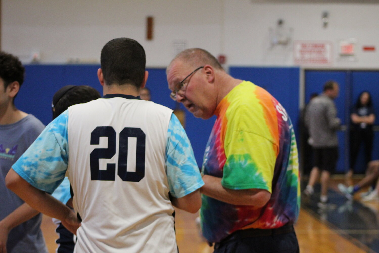 Hewlett High School Unified Basketball coach Bill Dubin, right, talks strategy with forward Jared Bostoff during a timeout in the May 24 game against Lawrence.