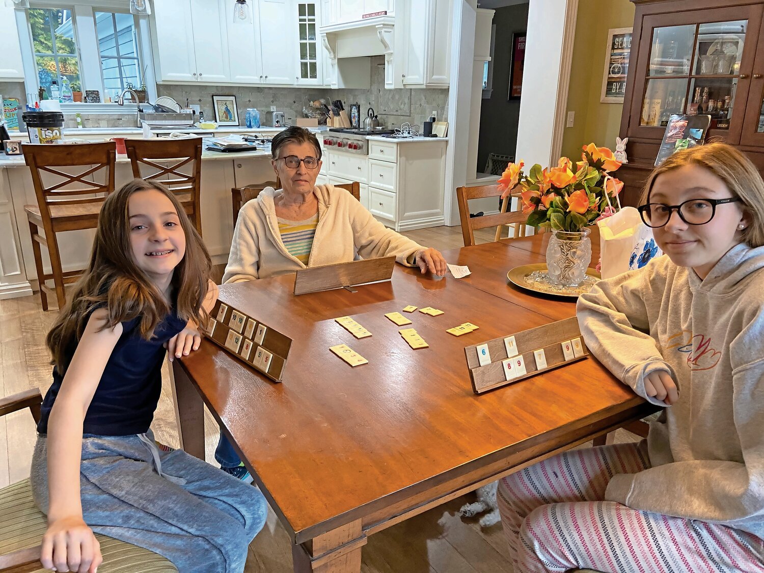 Seniors like Barbara Lillis, above center, spent much of the pandemic at home playing games with relatives including her granddaughters Jordan, left, and Jessica.