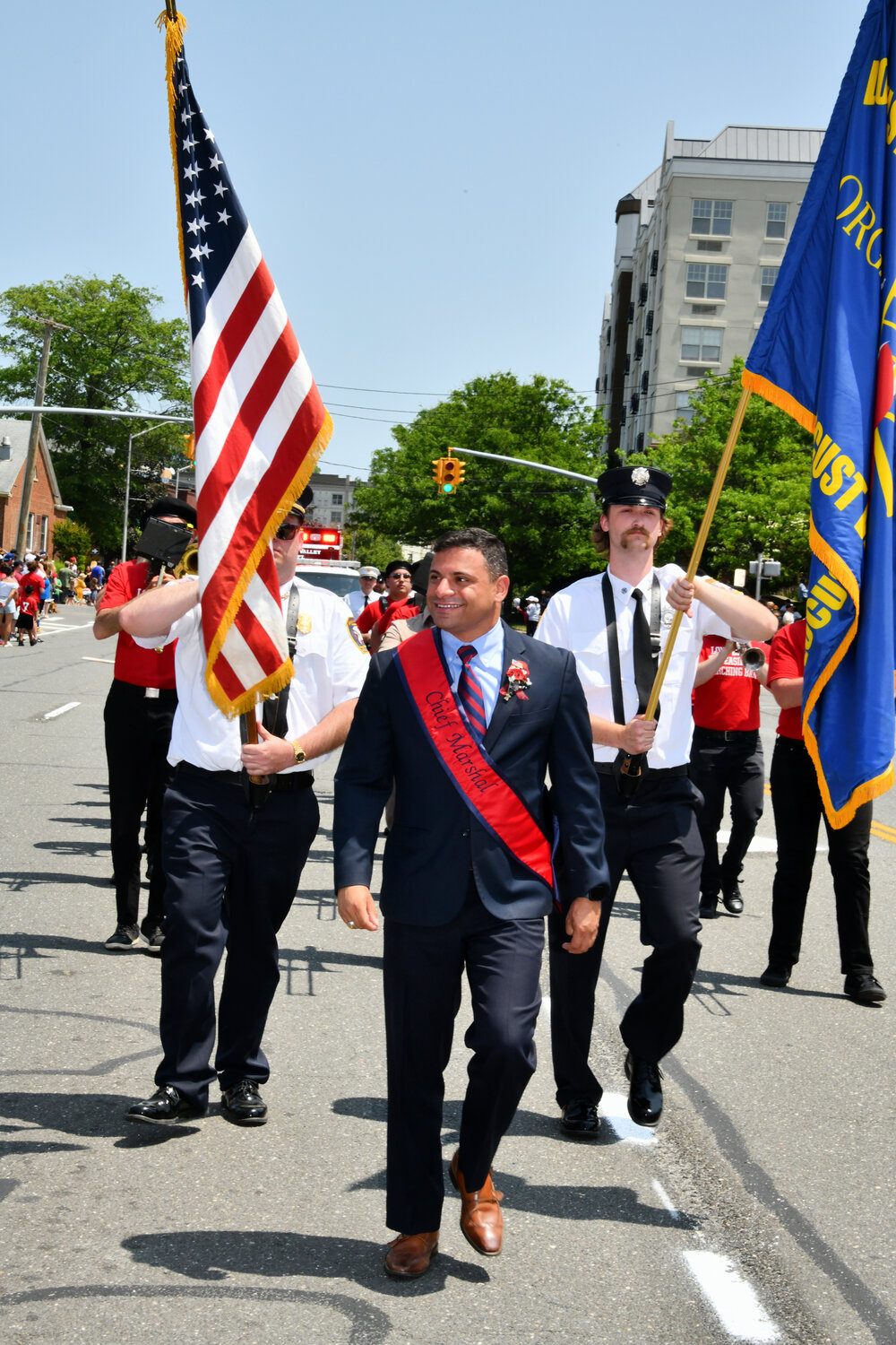 One of the parade’s grand marshal’s, Mike Mienko, right, marched in solidarity with the Fire Department.