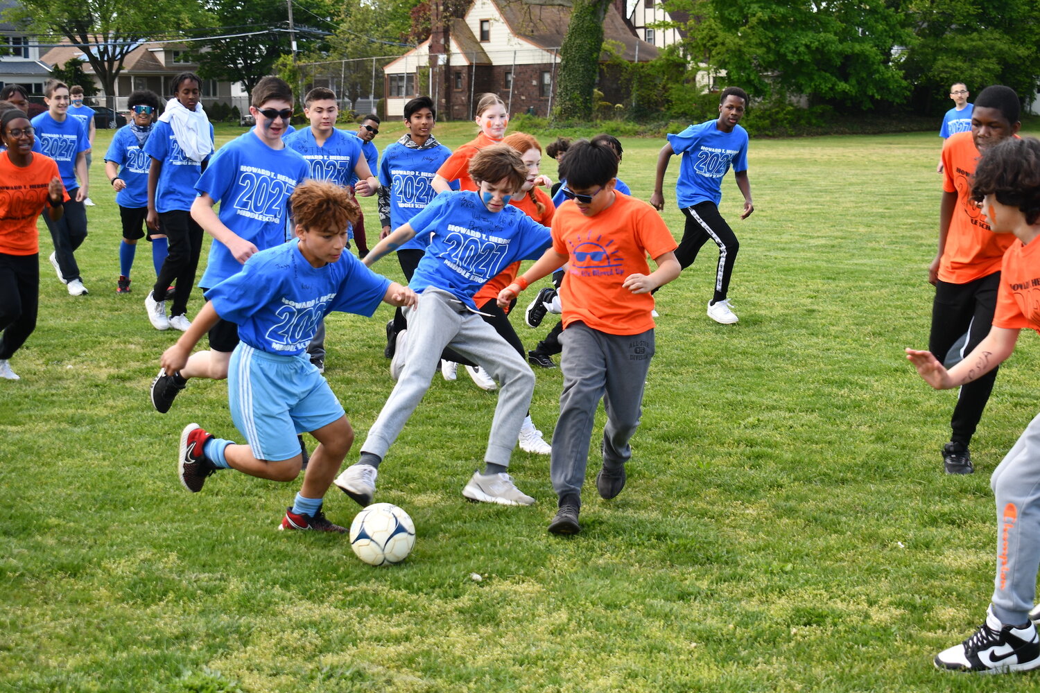 Seventh and eighth graders compete in a game of soccer during Sports Day at Howard T. Herber Middle School.