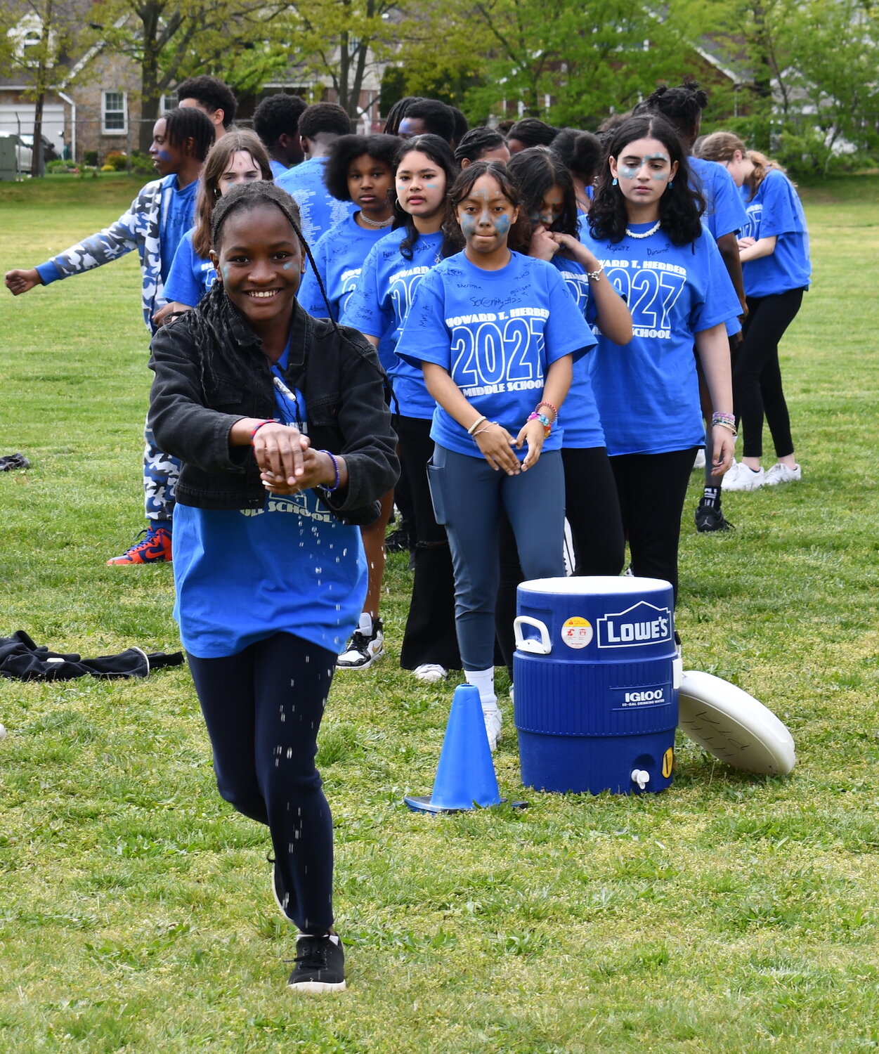 The eighth grade water bucket relay team sprints to the finish line during one of the final challenges.