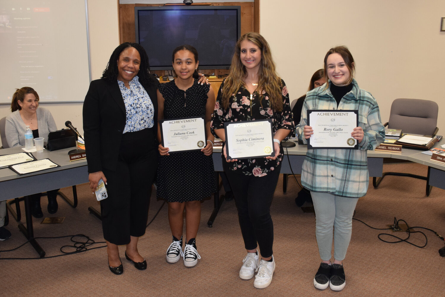 West Hempstead Secondary School students Juliana Cook, second from left, Sophia Ciminera and Rory Gallo were recognized by the district’s board of education for participating in the Nassau Music Educators Association’s All-County ensembles. Also pictured is Laila Sales, the district’s director of fine, performing and culinary arts.