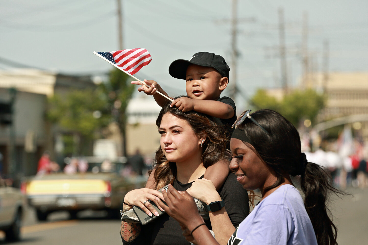 Madison Ander, 1-year-old Grayson Ander, and Shania Durandisse enjoy the parade.