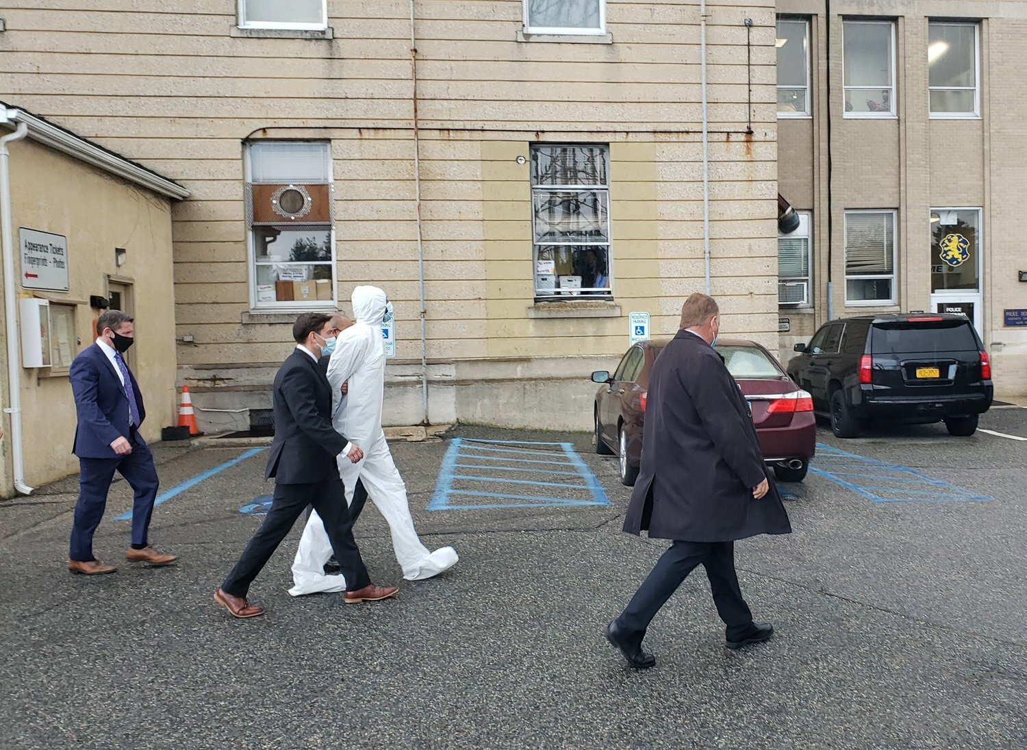 Gabriel DeWitt Wilson, here being escorted into court in 2021 wearing a while medical suit, was sentenced to 50 years to life for the murder of West Hempstead Stop & Shop manager Ray Wishropp, and the attempted murder of two other managers. Wilson worked in the store at the time, but wasn't scheduled to work on April 20, 2021, when the shooting occurred.