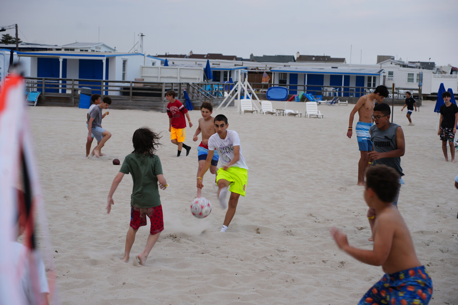 Alan Trakhtenberg kicking the soccer ball during one of the many games on the beach at the Hewlett Lawrence Soccer Club party.