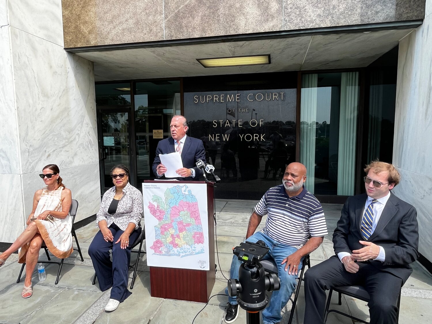 Attorney David Mejias speaks about what he calls ‘an illegal gerrymander’ alongside some of the plaintiffs and supporters of the lawsuit filed against the Nassau County Legislature over what they claim are new district maps that favor the majority Republicans over Democrats. Joining Mejias were, from left, Pamela Korn, Mimi Pierre-Johnson, Darien Ward and John Jarvis.