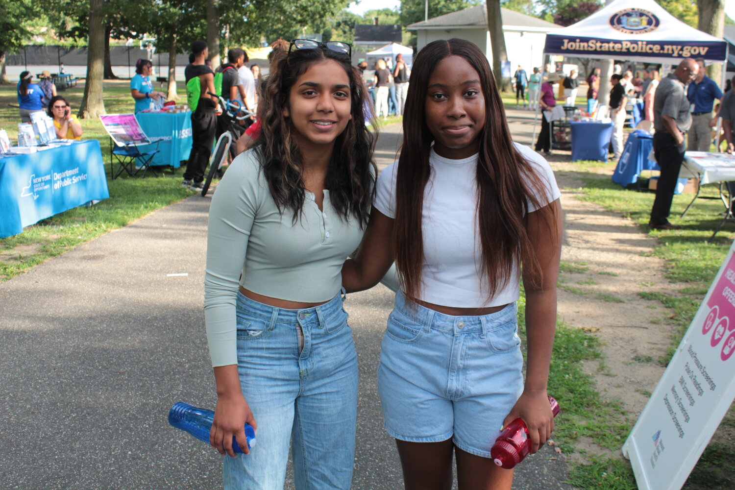 Baldwin Highschoolers Maekyla Massey and Sienna Hardy stroll through the park learning from booths and collecting goods.