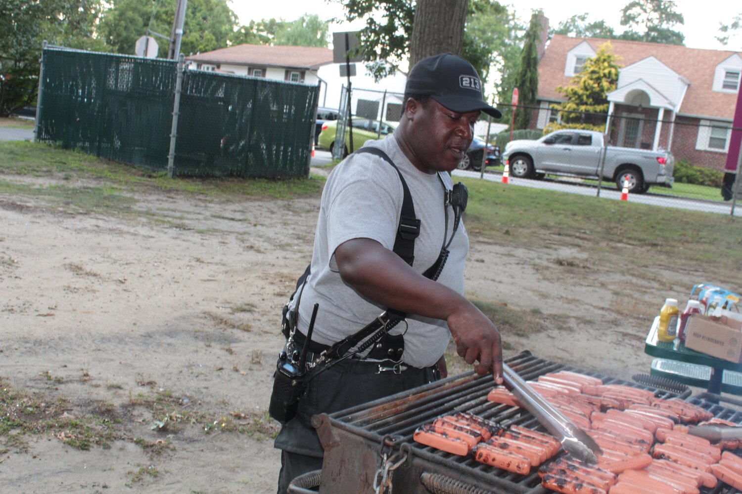 Mohamed Farghaly/Herald 
Randy Juene, captain of the Freeport Fire Department’s Hose 3, manning the grill at National Night Out in Bishop Frank O. White Park.