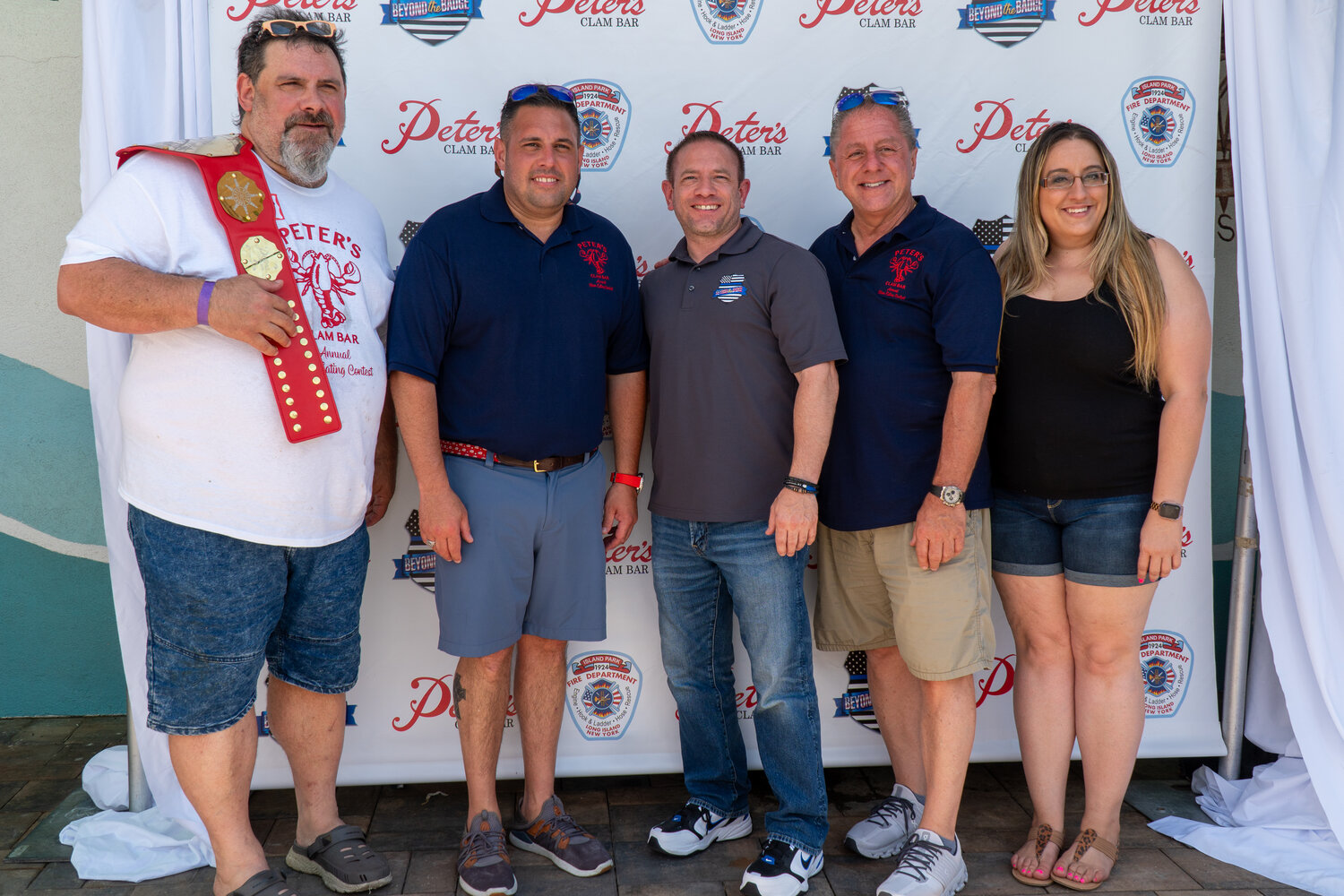 Joe Merchetti of Cheshire, Connecticut, won first place at the clam eating contest. With him, from left, were U.S. Rep. Anthony D’Esposito, Chris Panetta, Butch Yamali and Michelle Panetta.