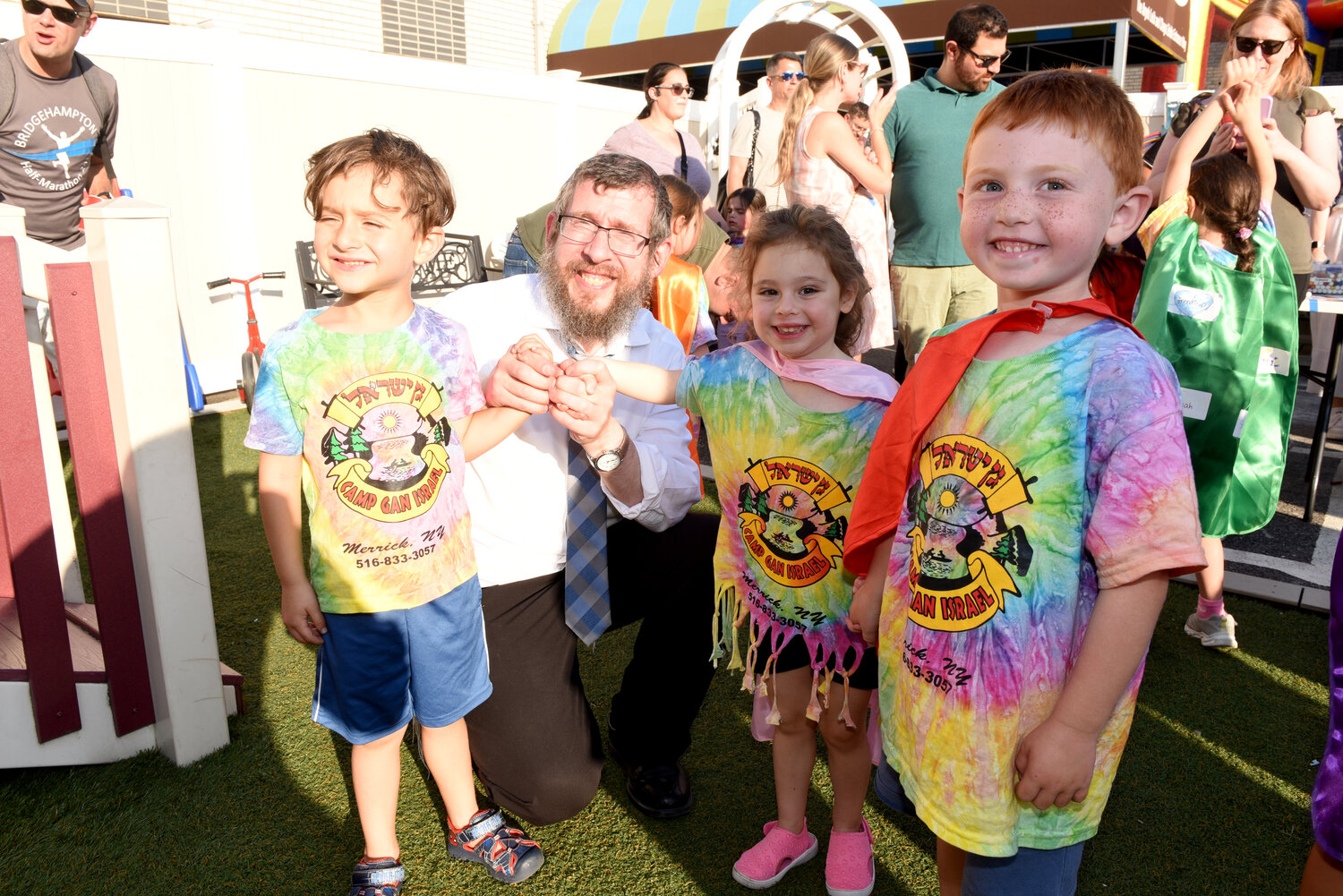 Rabbi Shimon Kramer with Logan Tenenhaus, Jaclyn Hahn and Landon Jitzchaki at the open house barbecue.
