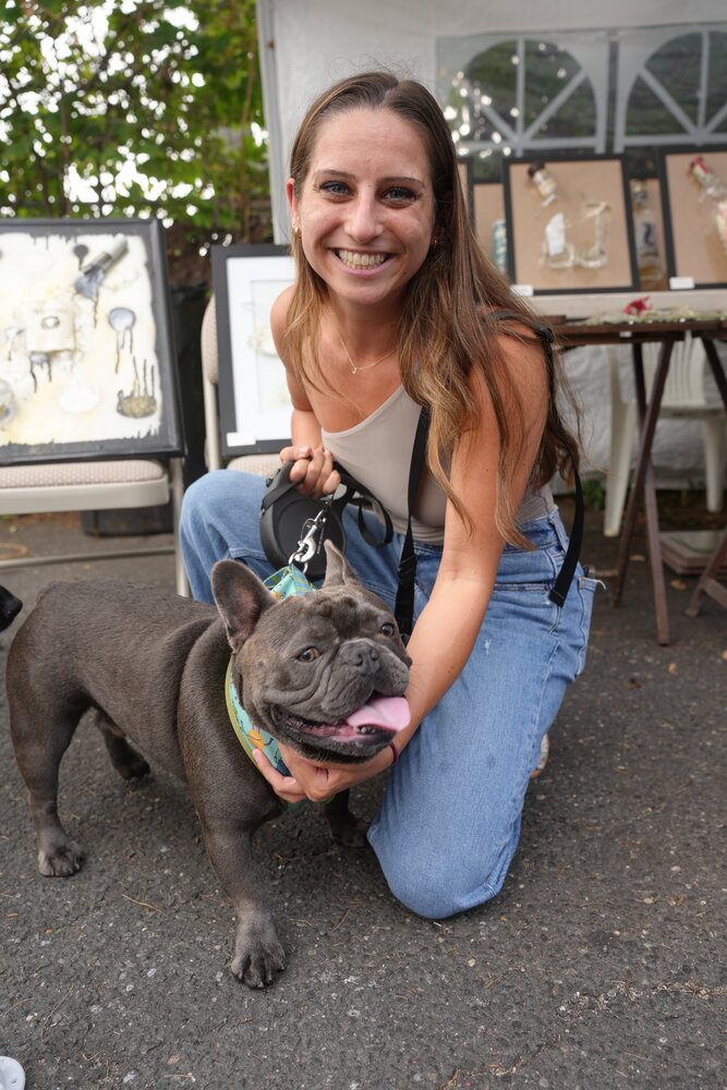 Bourbon & Brews, a charitable eatery on Merrick Avenue, hosted an outdoor puppy adoption drive on Aug. 12, with plenty of pups to be seen. Jackie Brigandi with dog, Jameson.
