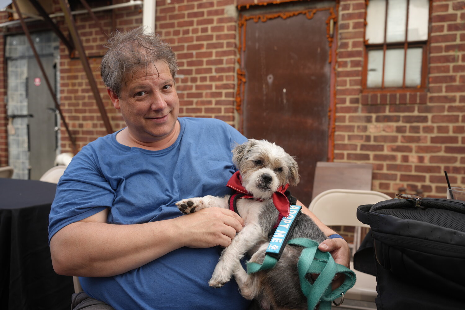 Keith Schneider met and played with pup, Tiny. Heavenly Angels is a foster-based rescue, with a P.O. Box in Ozone Park. All dogs are evaluated and socialized before adoption.