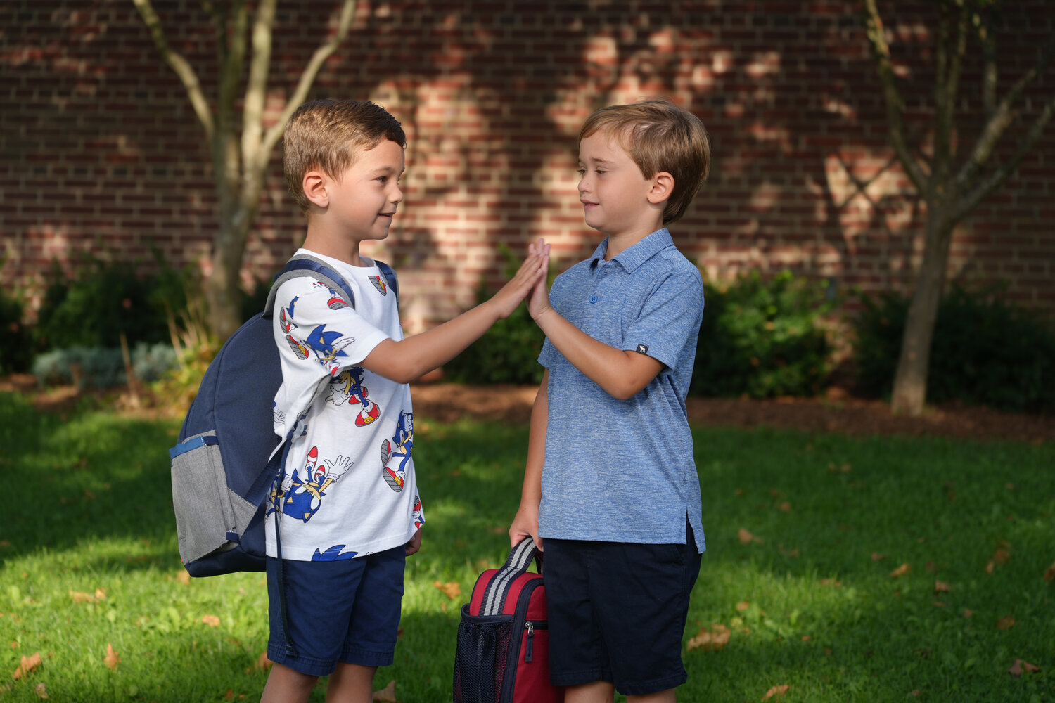 Ryan Burke and James Raffa celebrate their first day of Kindergarten at Covert Elementary with a high-five.