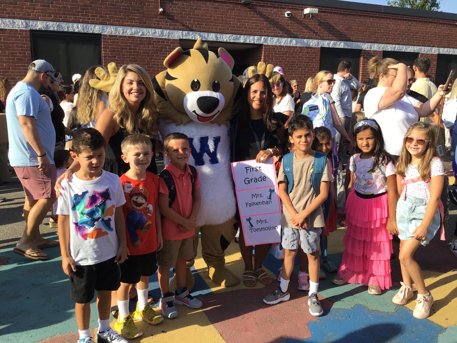 First grade students in Mrs. Falkenhan’s and Mrs. Tommolino’s class pause for a picture with the school mascot.