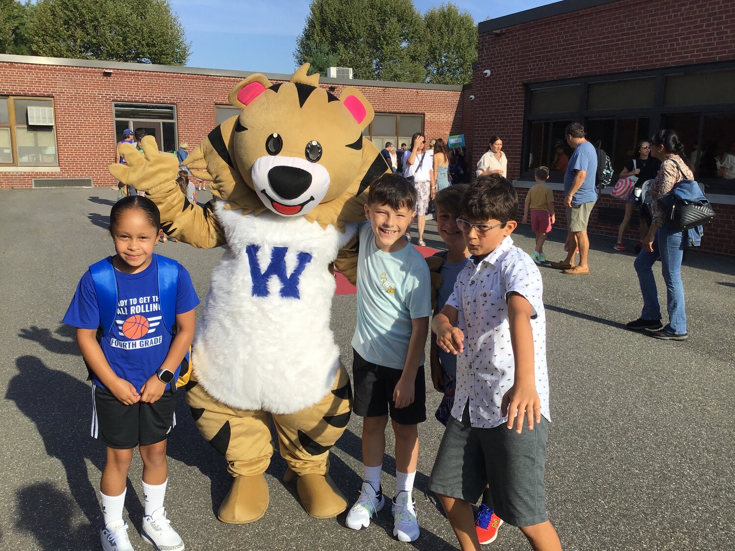 Kids pose for the camera with the Watson Elementary School mascot.