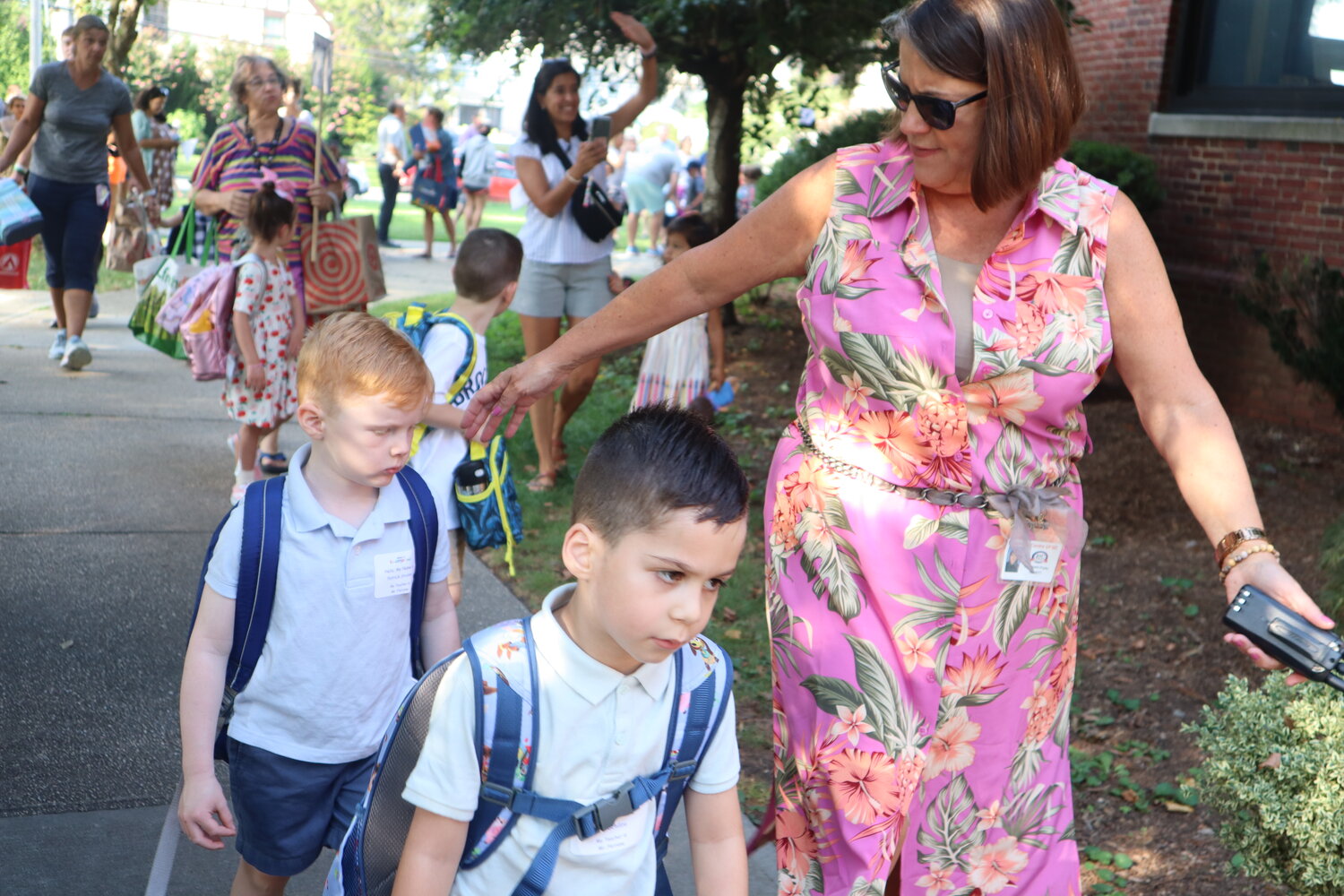 Hewitt Principal Elizabeth Pryke helps lead the students to their new classrooms.