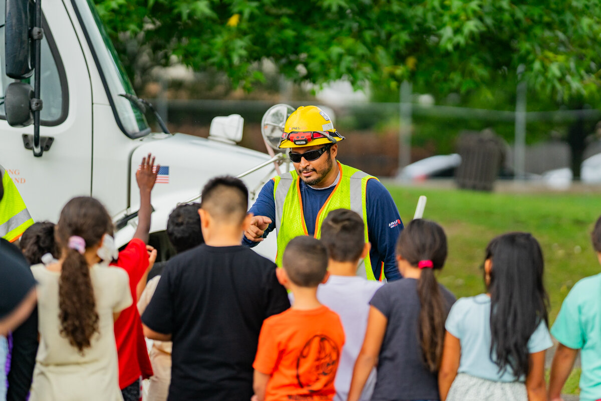 PSEG linesman Brandon Aries spoke to children at the Five Towns Community Center on the importance of truck and electrical safety at the Touch-a-Truck event on Aug. 8.
