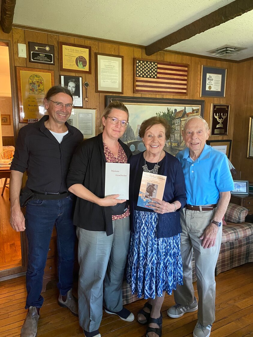 Christian Greis, Karolin Greis, Marion Blumenthal Lazan and Nathaniel Lazan came together to celebrate the completion of the book, ’Marions Kieselsteine,’ produced by Karolin Greis’ seventh grade class.