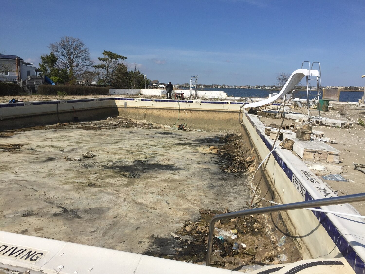 The pool of what was once the beach club is now filled only with debris.