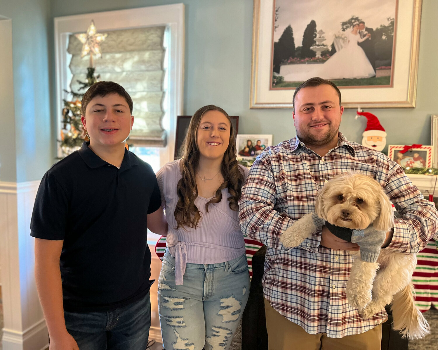 Winston the dog with her adopted family Andrew, 14, Allie, 20, and William, 23
