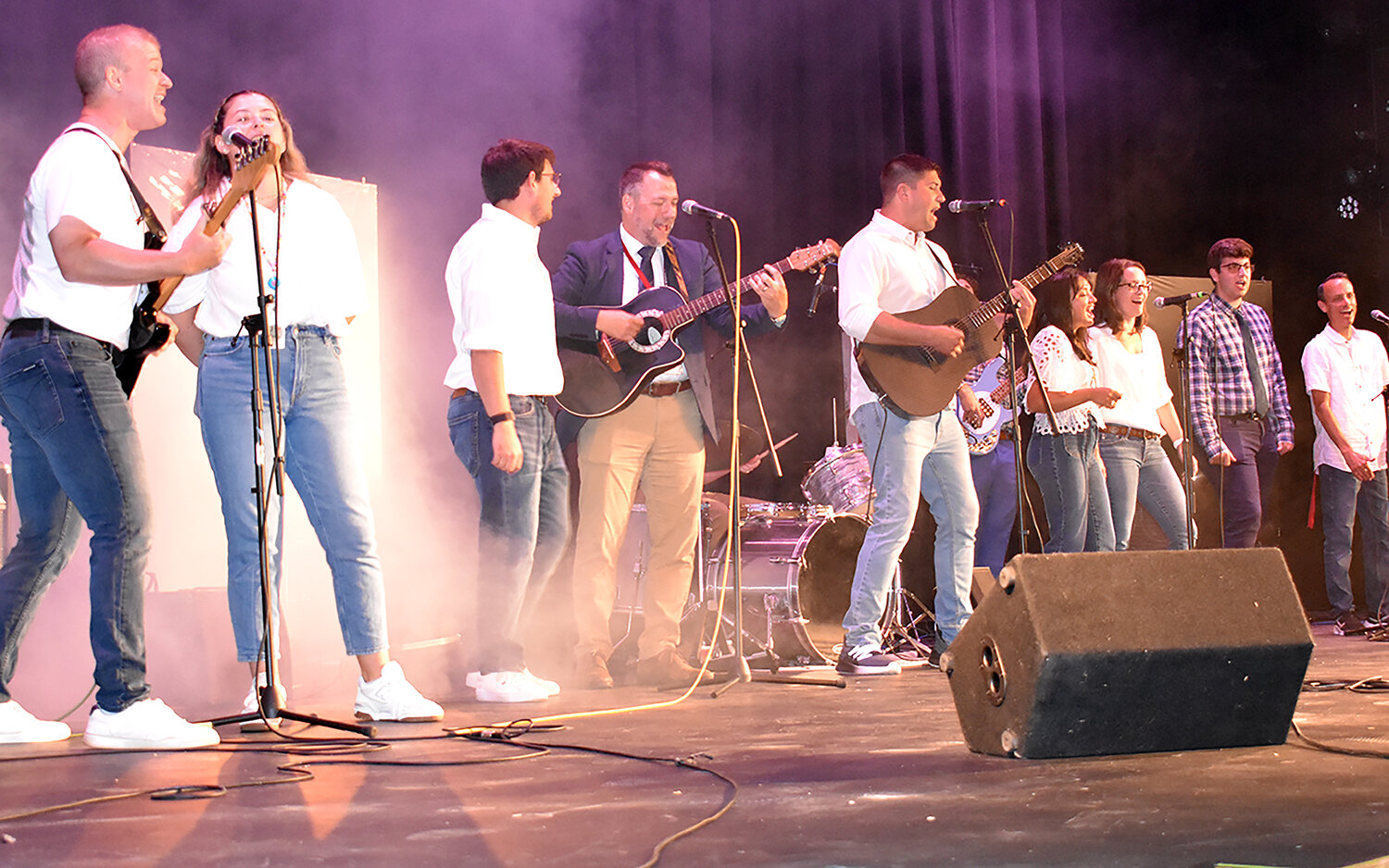 Chris Zublionis, fourth from left, and music teachers from the North Shore performed “Listen to the Music” to pump everyone up for the start of the school year.
