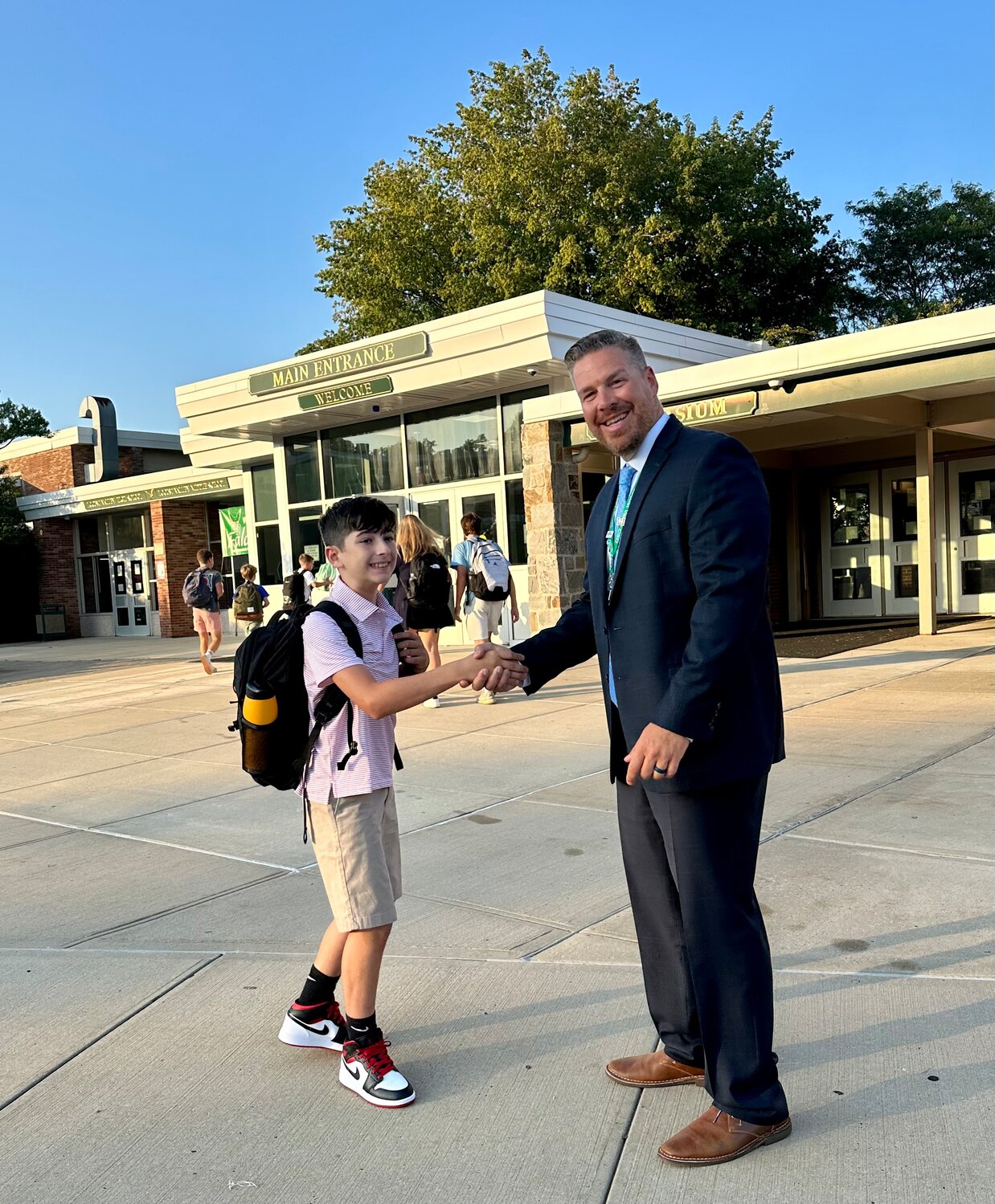 Locust Valley Middle School’s new principal Michael Cestaro, greeted students like sixth grader Declan Keaveney on their first day of school.