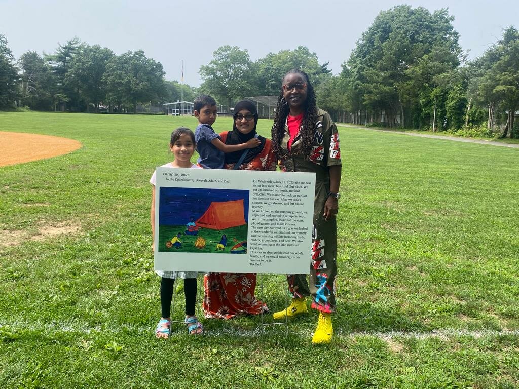 The Zafarali family (Afeeyah, Adeeb, and their mother Bibi H. Azeez) created a story about camping with help from Nichelle Rivers.
