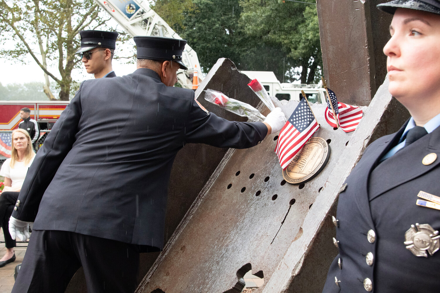For each of the 25 names read for community members who died in the attacks, a rose was placed on the World Trade Center steel at the Franklin Square 9/11 Memorial.
