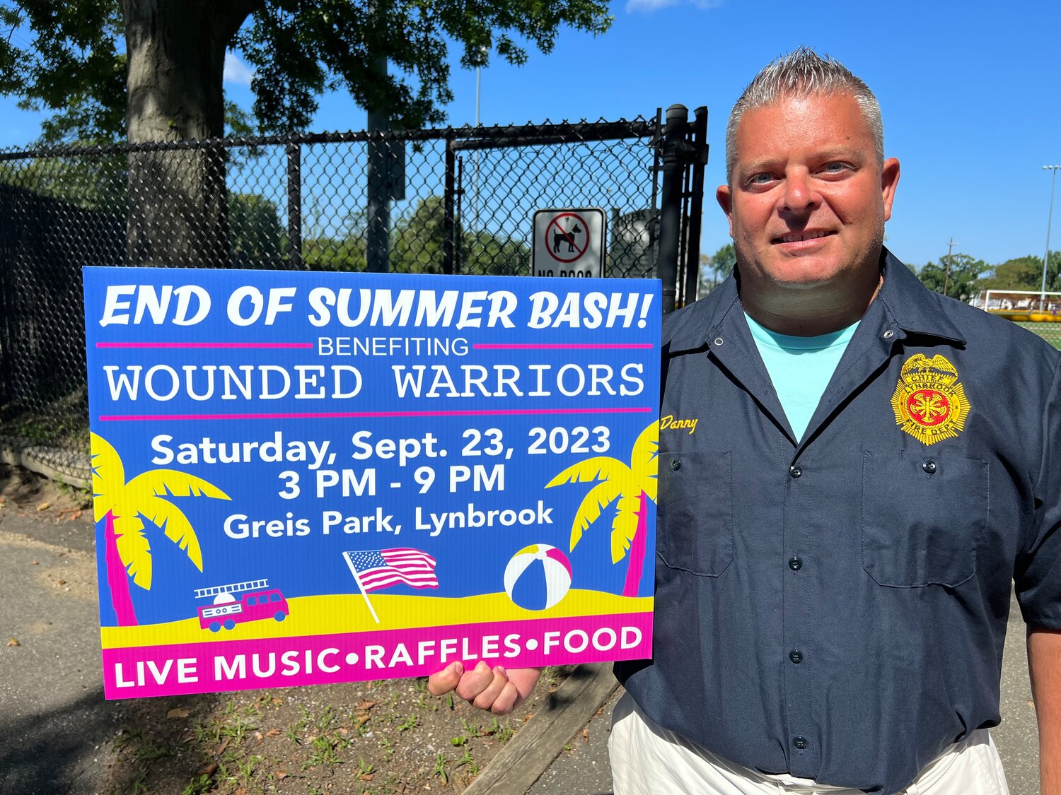 Lynbrook Fire Chief Danny Ambrosio with a lawn sign promoting the Lynbrook Fire Department’s fundraiser for Wounded Warriors on Sept. 23 at Greis Park.