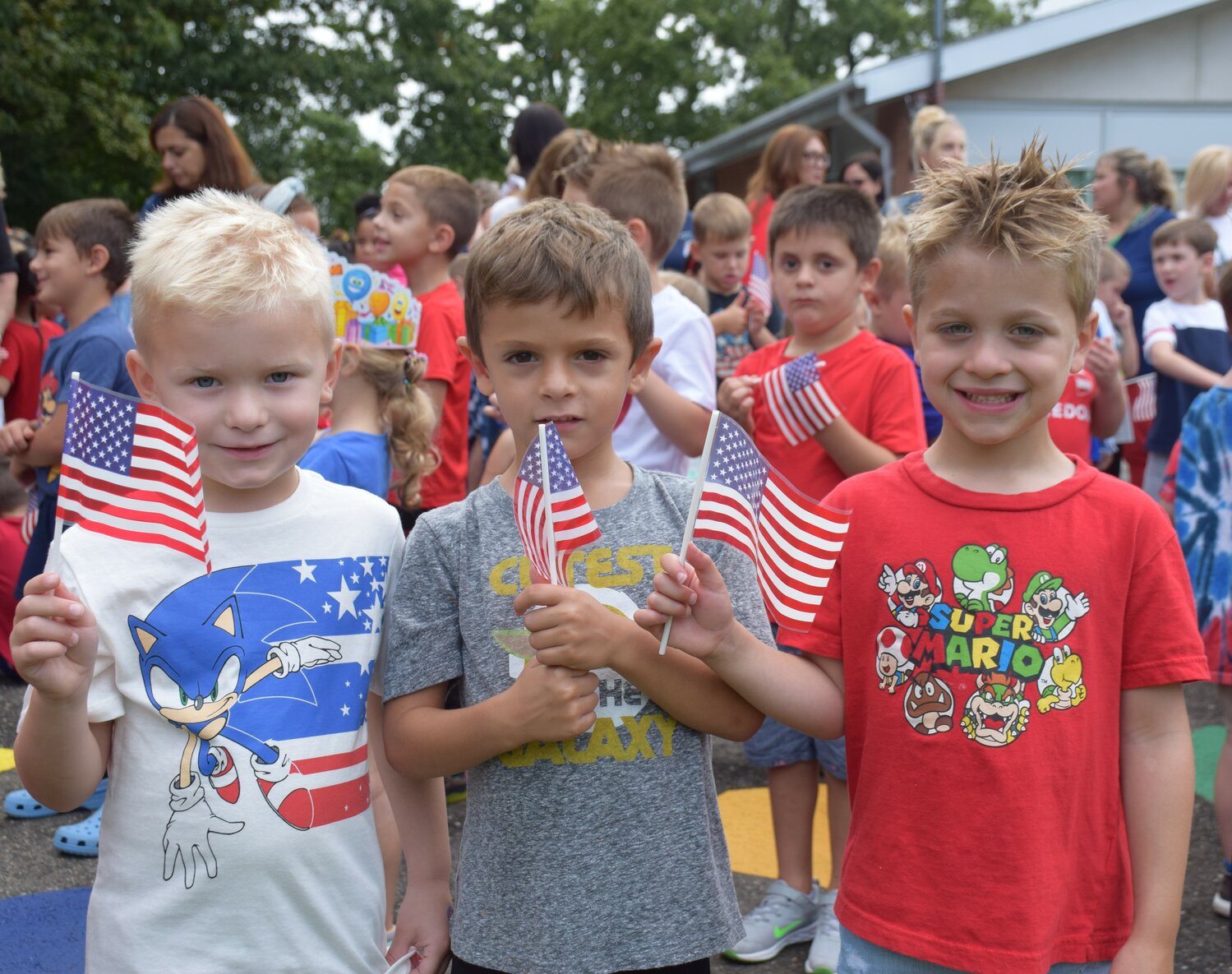 Bayville Primary School students James Laviano, left, Jack Lemma and Paul Chirichella planted flags in front of the school with their classmates to honor the victims of the Sept. 11 attacks.